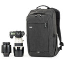 Thinktank BackStory 15 graphite camera backpack with laptop and tablet compartments next to camera lenses