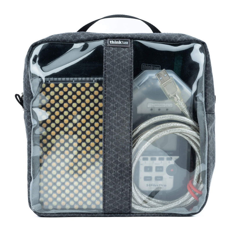 Thinktank Cable Management pouch in blue with clear panels showing organized cables and electronic accessories inside.