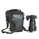 Thinktank Digital Holster 20 v3 black camera bag with adjustable straps beside mirrorless camera with attached zoom lens