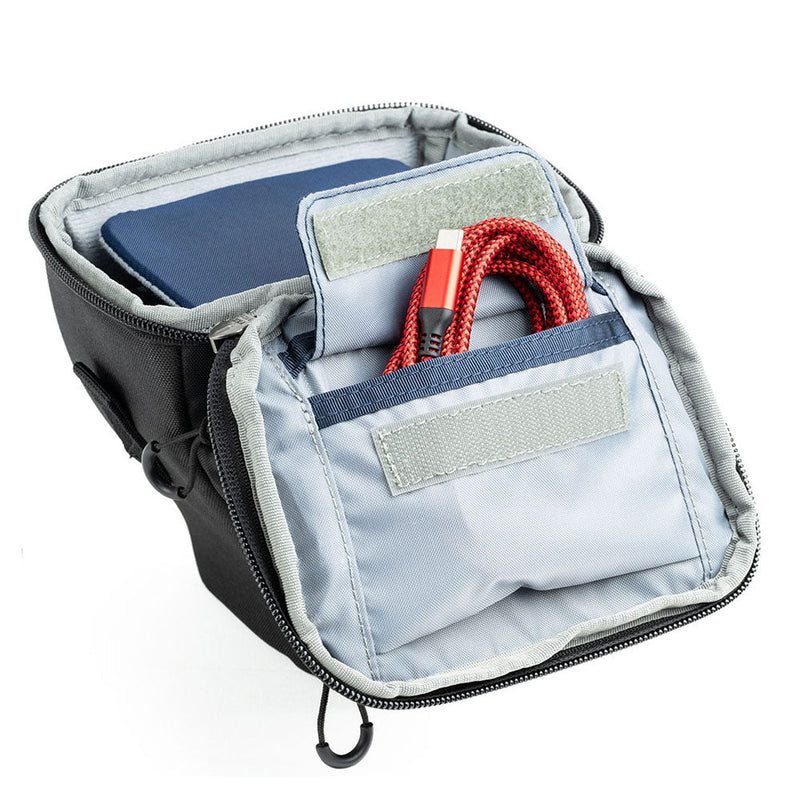 ThinkTank Digital Holster open with organized compartments for compact mirrorless cameras and accessories