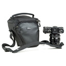 ThinkTank Digital Holster 5 v3 black compact camera bag with shoulder strap and mirrorless camera placed beside it