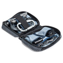 ThinkTank EDC Tech Pouch open with organized tech accessories including cables, chargers, and tools
