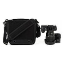 ThinkTank Retrospective 4 compact black camera shoulder bag next to a Sony mirrorless camera and lens