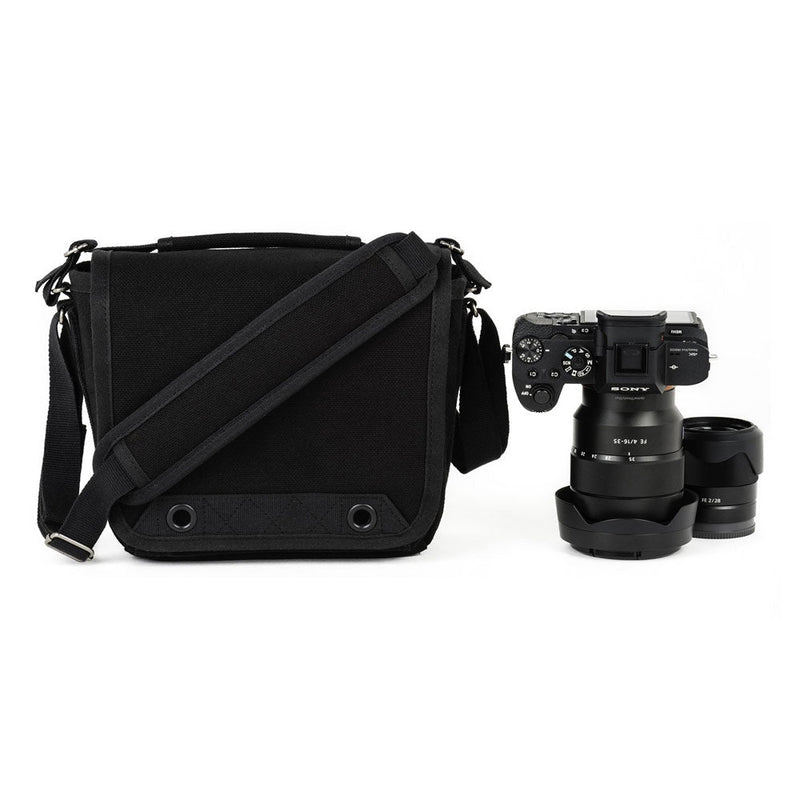 ThinkTank Retrospective 4 compact black camera shoulder bag next to a Sony mirrorless camera and lens