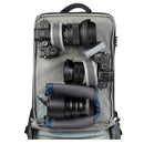 Camera backpack with camera equipment including lenses and a camera body on a white background