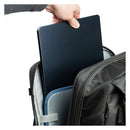 Person placing a black laptop into a backpack