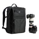 Black backpack with camera equipment on a white background