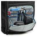 Open backpack showing organized compartments with items inside on a white background