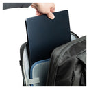 Person placing a black laptop into a backpack