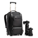 ThinkTank Walker Pro black rolling backpack with extended handle and photo camera gear next to it