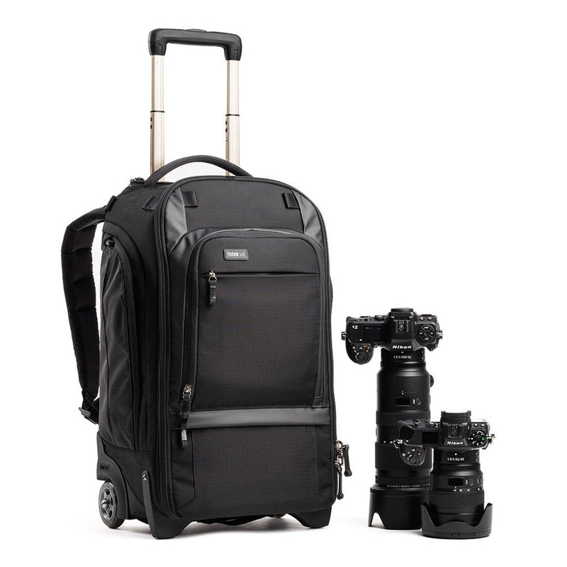 ThinkTank Walker Pro black rolling backpack with extended handle and photo camera gear next to it