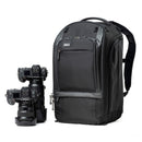 ThinkTank Walker Pro 30L black camera backpack with padded laptop compartment and tripod attachments next to professional Nikon cameras