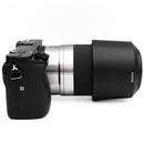 Sony a6000 with silver 55-210mm lens on a white background