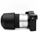 Sony a6000 with silver 55-210mm lens on a white background