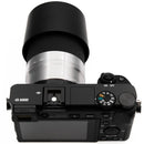 Sony a6000 with silver 55-210mm lens on a white background