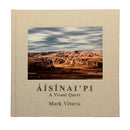 Book cover of 'Aisinaipi: A Visual Quest' by Mark Vitaris with a landscape photograph on the cover.