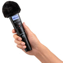 Hand holding Zoom M2 MicTrak portable audio recorder with windscreen and LCD display