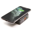 iQ All-in-One Power Station with Qi wireless charging and dual USB ports charging a smartphone