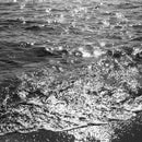 Black and white photo of shimmering ocean waves captured with Lomography Babylon Kino 35mm ISO 13 film