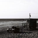 Black and white beach scene with lifeguard tower and vehicle shot on Fantôme Kino B&W Film 35mm with high contrast and low grain
