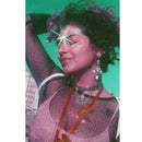 Portrait of a woman with sparkling jewelry and purple hues using Lomography LomoChrome Purple 35mm film