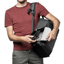 Man holding LowePro Flipside Backpack 300 AW III with camera inside, showing backside access and padded camera compartment