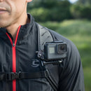 Man wearing Peak Design P.O.V. Kit v2 mounted GoPro camera on chest strap for point-of-view video recording outdoors