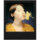 Polaroid Originals i-Type Colour Film black frame instant photo of person with yellow flower