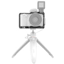 SmallRig Cage for Sony ZV-E10 with accessory mounts, anti-twist lock, quick release plate, cold shoe slots, and protective rubber pads on tripod.