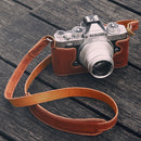 SmallRig Leather Half Case with shoulder strap for Nikon Z fc camera on wooden surface