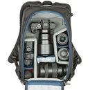 Thinktank BackStory 13 camera backpack with rear-panel opening showing organized camera gear and lenses.
